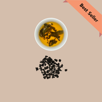 Deep amber liquor of brewed sunset dark roast oolong tea in a white cup, emphasizing the rich color